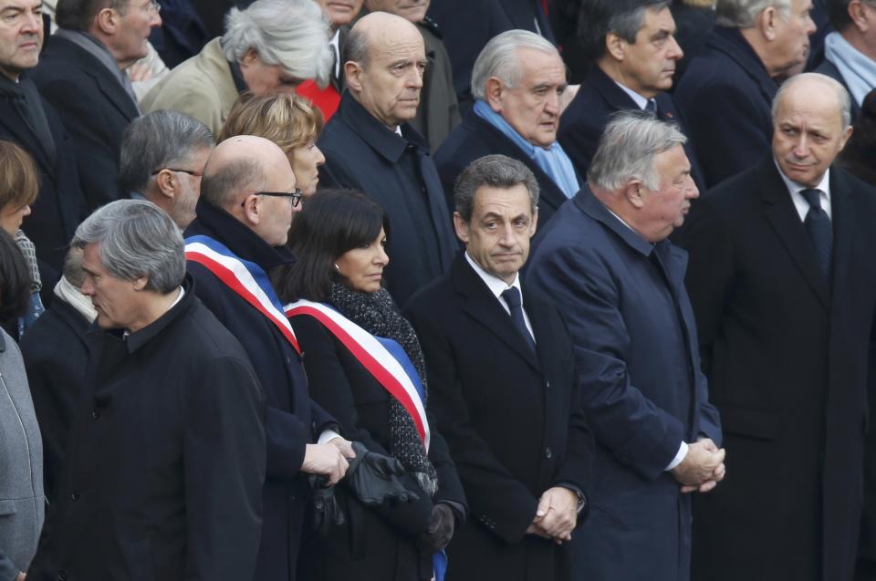 Paris Mayor Anne Hidalgo (3rdL), Nicolas Sarkozy (3rdR), former French president and current head of the Les Republicains political party, President of the French Senate Gerard Larcher (2ndR), and French Foreign Minister Laurent Fabius (R) attend a ceremony to pay a national homage to the victims of the Paris attacks at Les Invalides monument in Paris, France, November 27, 2015. (REUTERS/Charles Platiau)