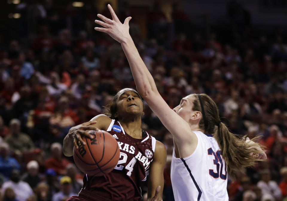 Texas A&M's Jordan Jones (24) wins a rebound against Connecticut's Breanna Stewart (30) during the first half of a regional final game in the NCAA college basketball tournament in Lincoln, Neb., Monday, March 31, 2014. (AP Photo/Nati Harnik)