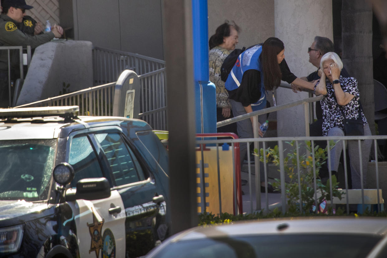 A grief counselor comforts a parishioner after a John Chou allegedly opened fire at Geneva Presbyterian Church in Laguna Woods, Calif.