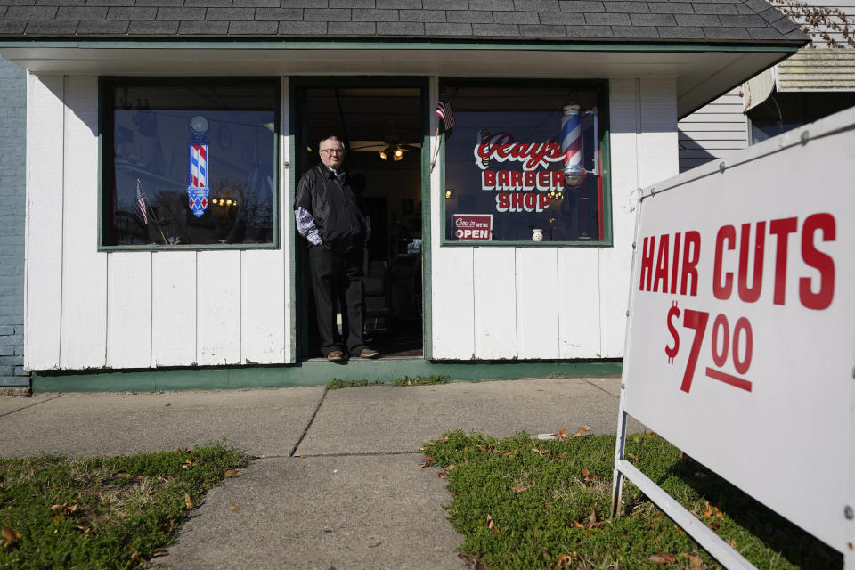 Ray Nicoson stands at the entrance of his barber shop, Wednesday, Nov. 11, 2020, in Terre Haute, Ind. Indiana's Vigo County had been America’s more reliable presidential bellwether, voting in line with the rest of the nation since 1956. But that winning streak ended this year, as it did for nearly all the country’s bellwethers, most of them blue-collar, overwhelmingly white communities in the Rust Belt. (AP Photo/Darron Cummings)