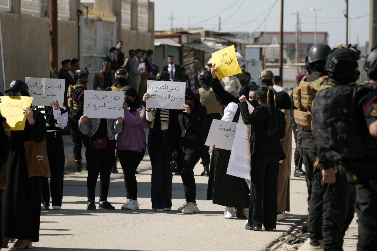 Demonstrators hold placards as they protest on the killing of Tiba Ali, a YouTube star who was recently killed by her father, in Diwaniya, Iraq, Sunday, Feb. 5, 2023. Iraq's Interior Ministry spokesman Saad Maan on Friday announced that Tiba Ali was killed by her father on Jan. 31, who then turned himself into the police. (AP Photo/Hadi Mizban)