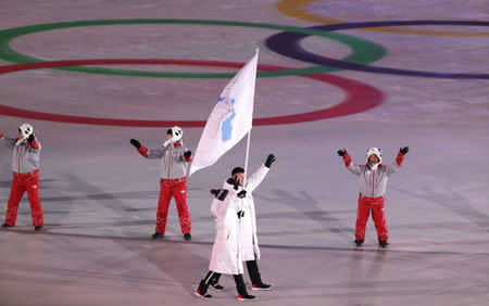 Pyeongchang 2018 Winter Olympics – Opening ceremony – Pyeongchang Olympic Stadium - Pyeongchang, South Korea – February 9, 2018 - Hwang Chung Gum and Won Yunjong of Korea carrie the unification flag during the opening ceremony. REUTERS/Kim Kyung-Hoon/Files