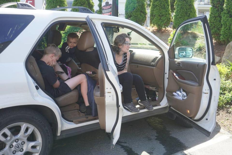 Six children are living with their mother, Cassandra, and father, David, in their family vehicle on July 27, 2023, in Bellingham, Wash. David works nearby while the family sits in the car with the air conditioning running to stay comfortable.