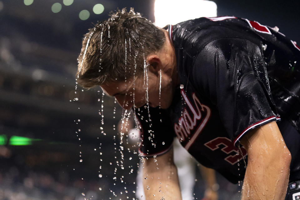 Washington Nationals' Jacob Young is doused in water after hitting a walk-off single during the ninth inning of a baseball game against the New York Mets, Wednesday, Sept. 6, 2023, in Washington. (AP Photo/Stephanie Scarbrough)