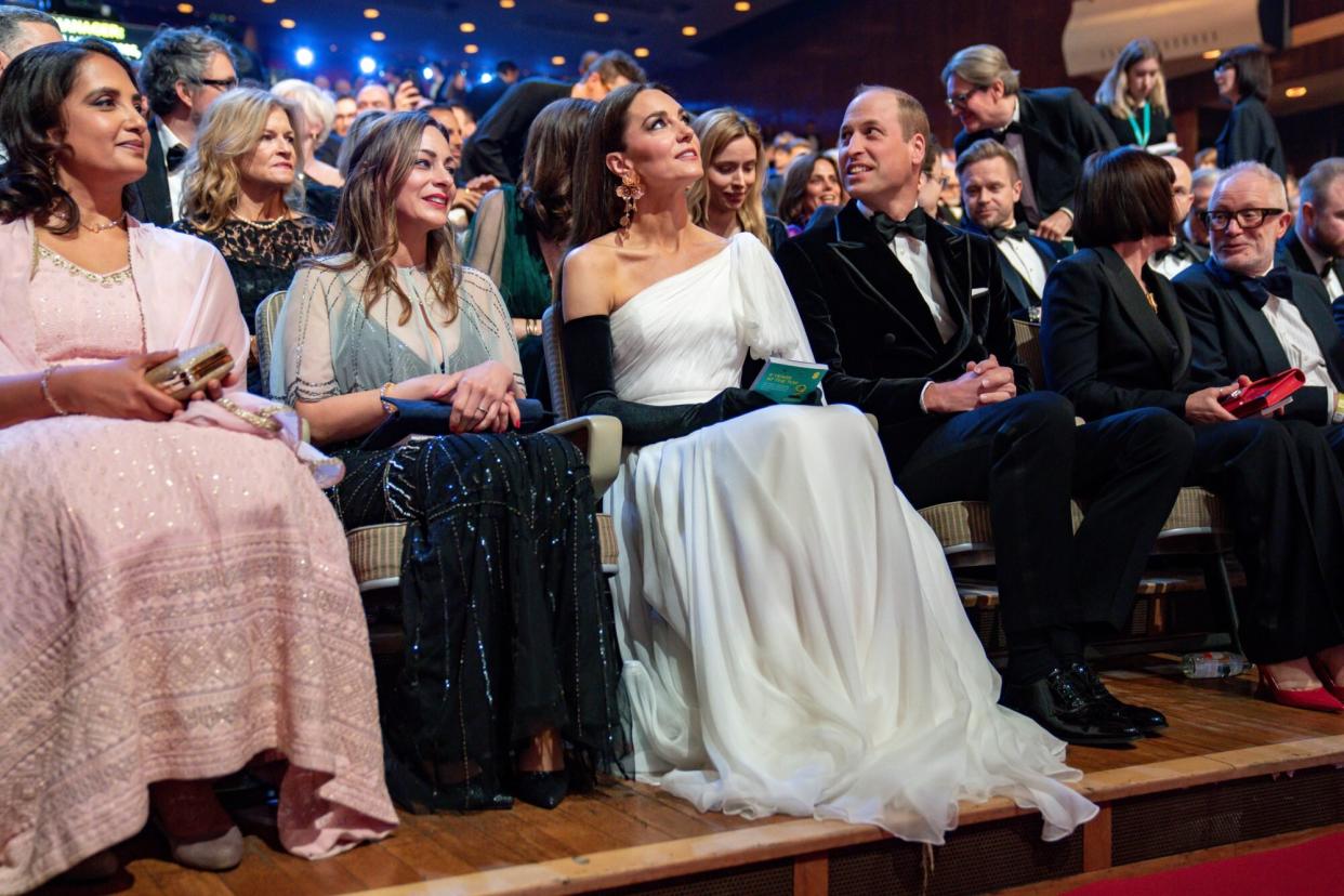 LONDON, ENGLAND - FEBRUARY 19: (L to R) Emma Baehr (BAFTA Director of Awards & Content), Catherine, Princess of Wales and Prince William, Prince of Wales during the EE BAFTA Film Awards 2023 at The Royal Festival Hall on February 19, 2023 in London, England. (Photo by Scott Garfitt/BAFTA via Getty Images)