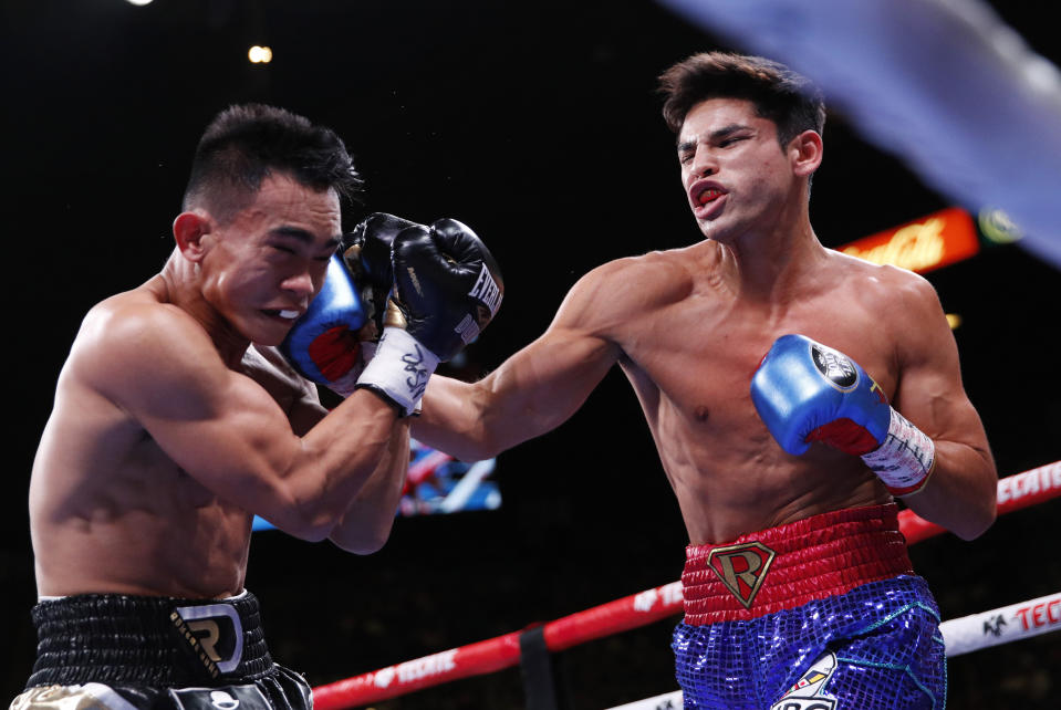 Ryan Garcia hits Romero Duno in a lightweight boxing bout Saturday, Nov. 2, 2019, in Las Vegas. (AP Photo/John Locher)