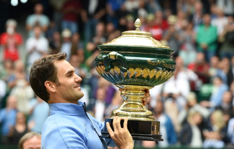 Roger Federer poses with his trophy after winning his final match against Alexander Zverev, at the Gerry Weber Open tennis tournament in Halle, western Germany, on June 25, 2017