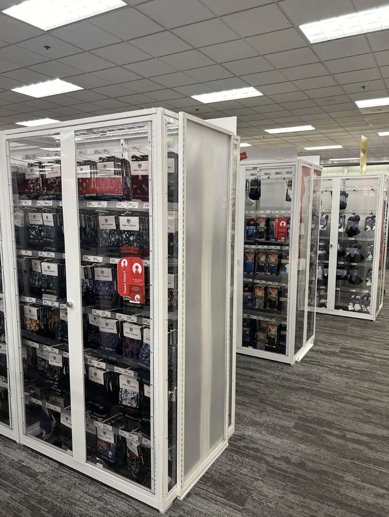 Aisle in a store with multiple clear security cases displaying electronic accessories