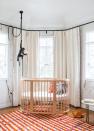 <p>Orange is such an underrated nursery color. In this one designed by <a href="https://www.etcforshort.com/" rel="nofollow noopener" target="_blank" data-ylk="slk:ETC.era;elm:context_link;itc:0;sec:content-canvas" class="link ">ETC.era</a>, the bold rug sets the tone for an energizing, fun, and sweet space. Keep things soft and cozy with a warm cream as opposed to a cool white. And how could we not mention that awesome monkey pendant? </p>