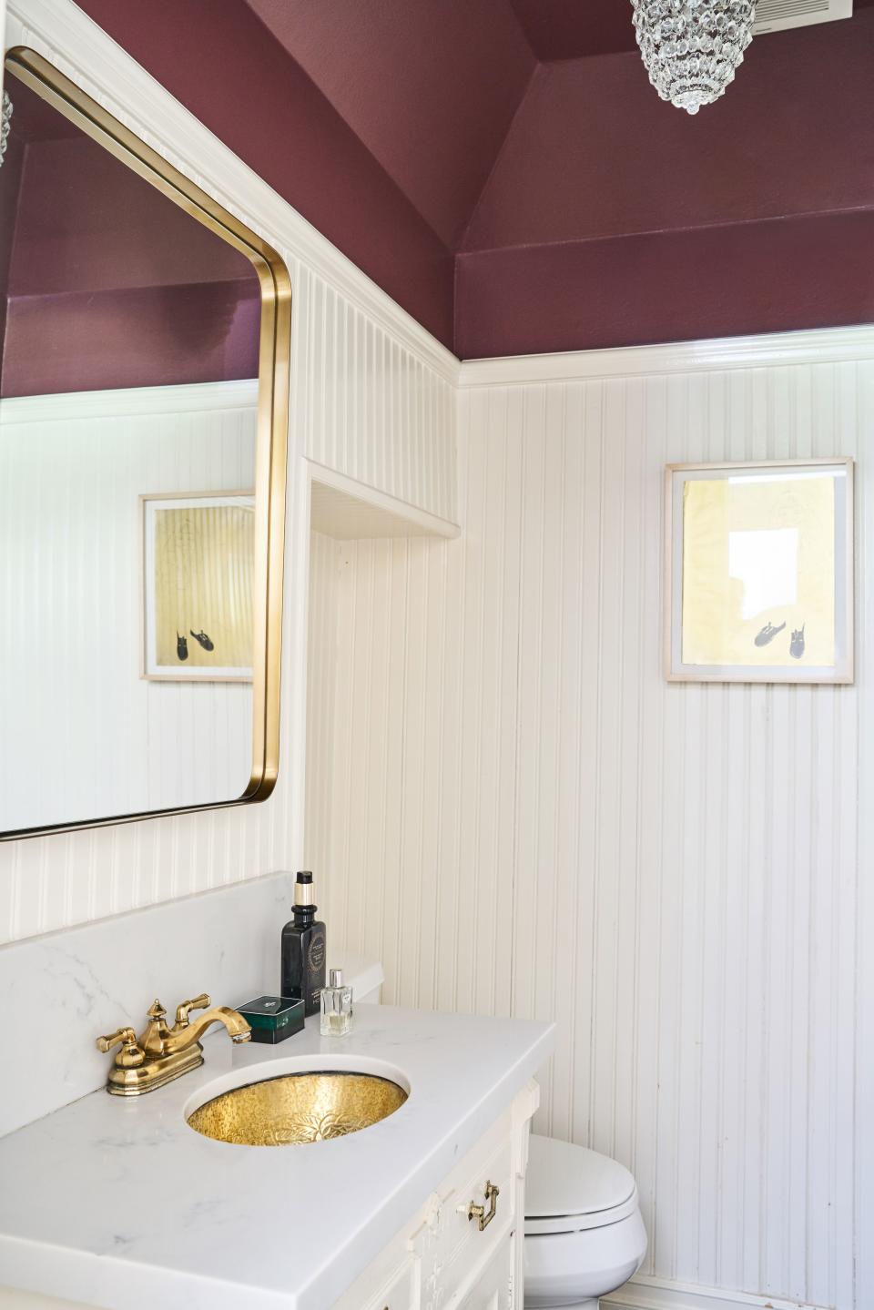 "I said, 'Let's go all out with color,'" Wark says. And Blair agreed, hence the plum ceiling in the powder room off the entryway.