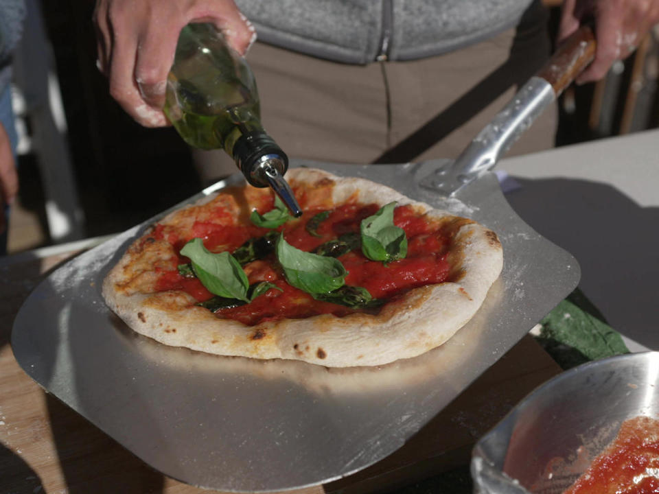 In Naples, the birthplace of pizza, pizza makers (or pizzaioli) extoll the traditions of wood-burning ovens. But with the growing popularity of at-home pizza ovens, experts are now offering online courses for pizza enthusiasts around the world. / Credit: CBS News