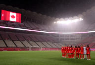 <p>Team Canada pauses for the national anthem prior to the women's Group E soccer match between Canada and Great Britain at Kashima Stadium.</p>