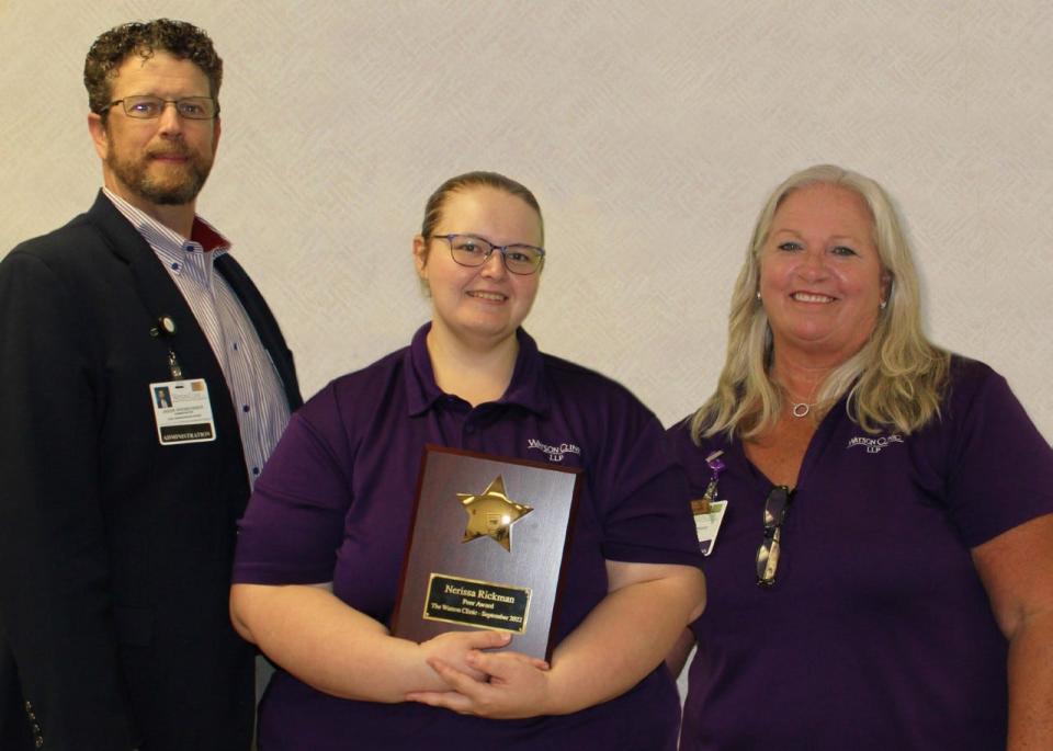 Nerissa Rickman (center) displays her PEER Award plaque next to Watson Clinic Chief Administrative Officer Jason Hirsbrunner (left) and supervisor Marilyn Rhodes (right).