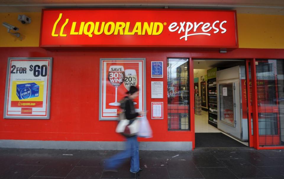 Pedestrian walks past a Coles Liquorland Express store