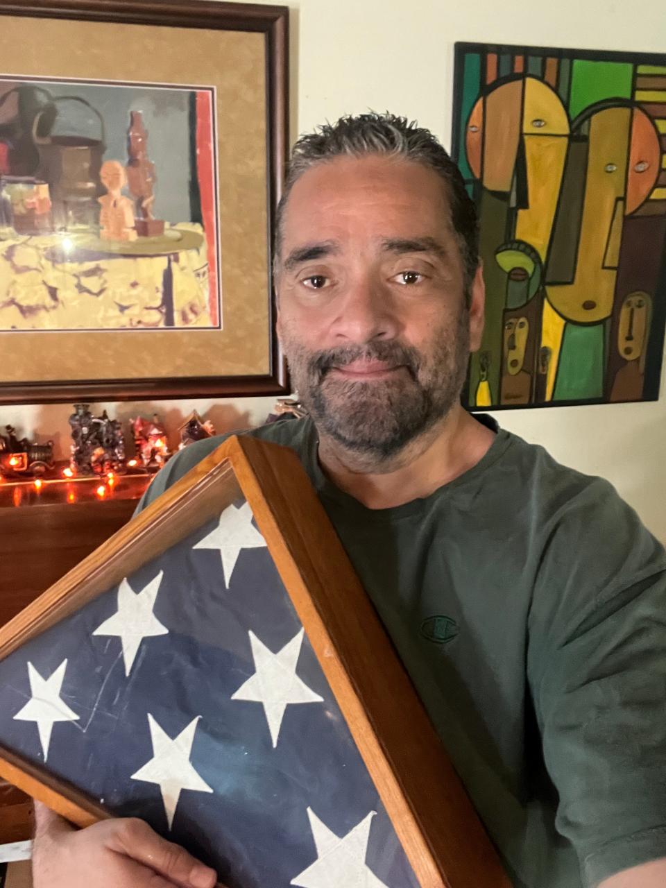 Engagement Editor John A. Torres proudly holds the American flag presented to his family upon his grandfather, Juan Calderon's death in 1968. Calderon served during World War I.
(Credit: Photo provided)