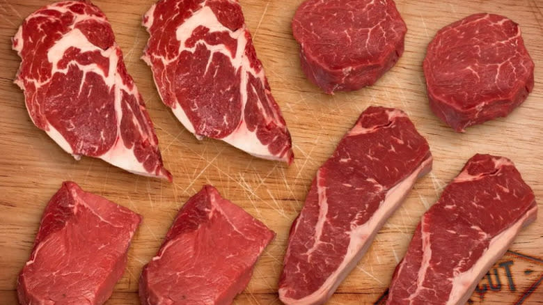 Raw steak cuts on cutting board