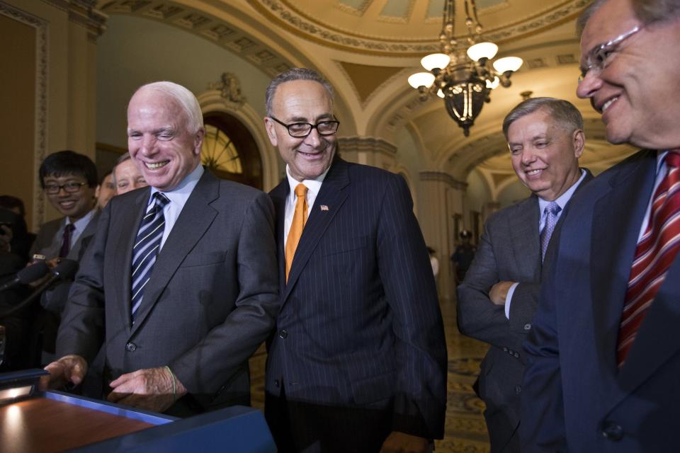 Sen. Chuck Schumer, D-N.Y., center, and members of the Senate's bipartisan "Gang of Eight" who crafted the immigration reform bill, leave the Senate floor after final passage, at the Capitol in Washington, Thursday.  From left to right are Sen. John McCain, R-Ariz., Sen. Chuck Schumer, D-N.Y., Sen. Lindsey Graham, R-S.C., and Sen. Robert Menendez, D-N.J. (AP Photo/J. Scott Applewhite)
