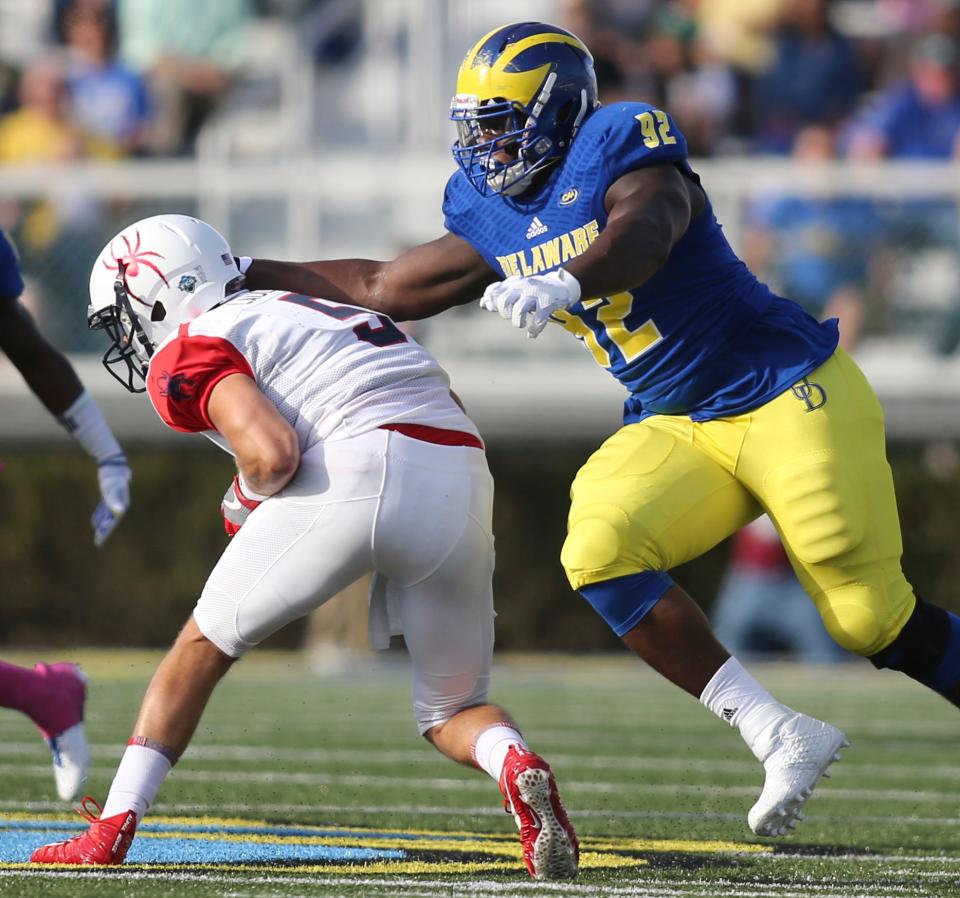 Delaware's Bilal Nichols grabs for Richmond quarterback Kyle Lauletta in the first quarter at Delaware Stadium Saturday.