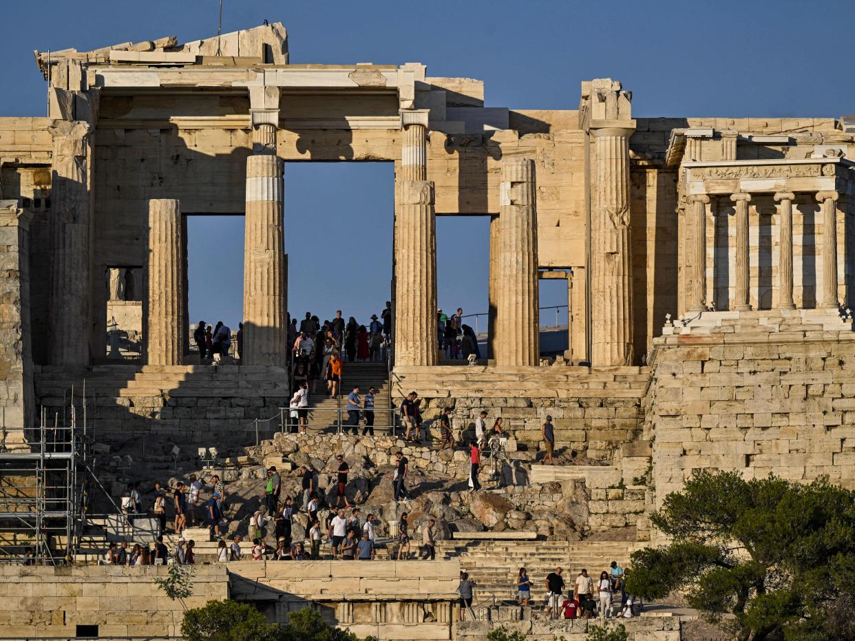 Tourists on the propylaea of the Acropolis in Athens in June 2023.