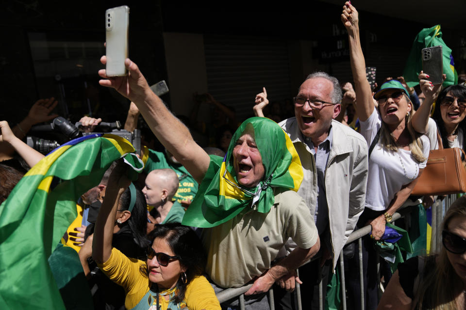 Supporters of Brazilian President Jair Bolsonaro attend his re-election campaign rally in Juiz de Fora, Minas Gerais state, Brazil, Tuesday, Aug. 16, 2022. Bolsonaro formally began his campaign for re-election in this town where he was stabbed during his 2018 campaign. General elections are set for Oct. 2. (AP Photo/Silvia Izquierdo)