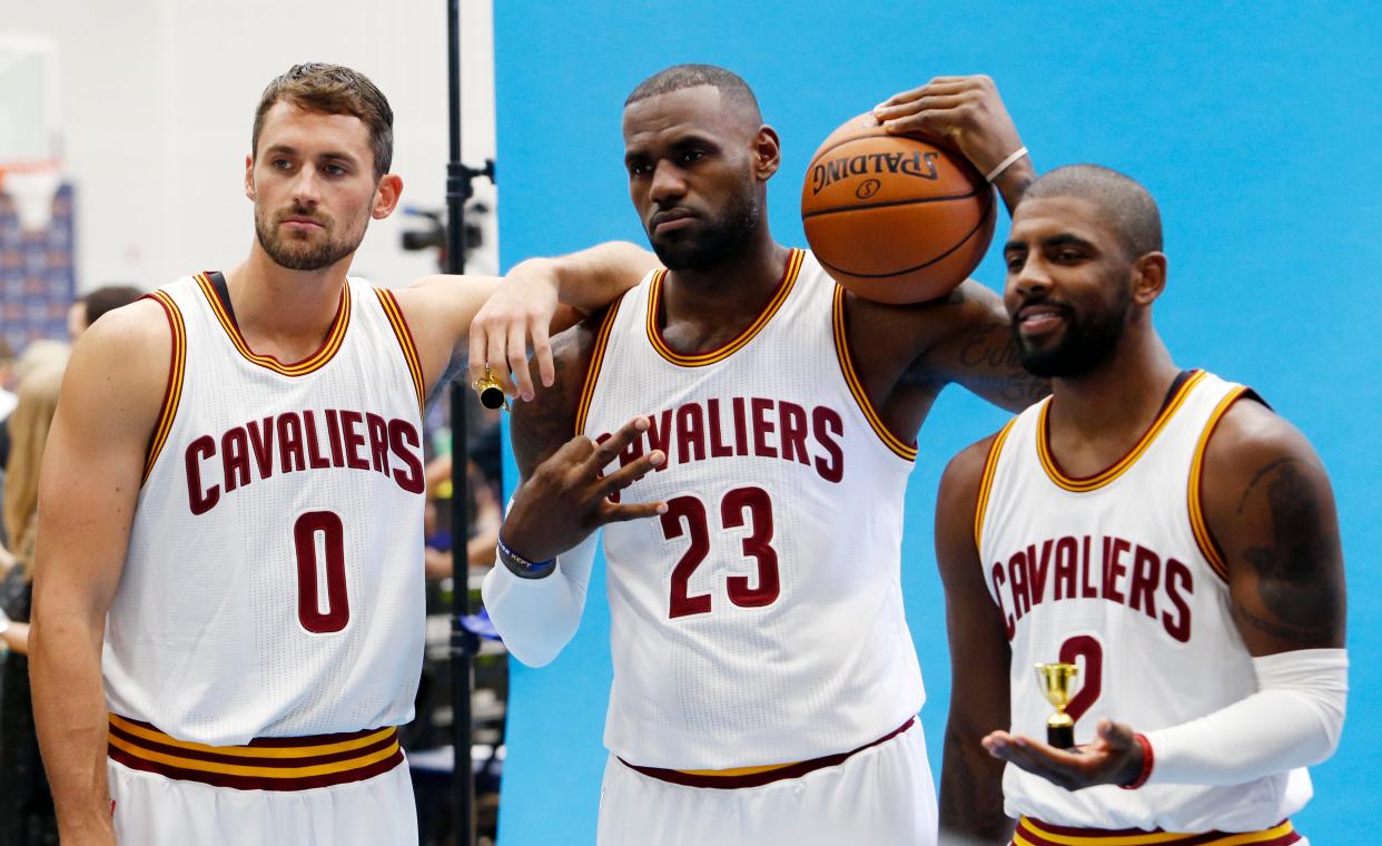 Cavaliers forward Kevin Love (0), LeBron James (23) and Kyrie Irving (2) pose for photographs during media day, Monday, Sept. 26, 2016.
