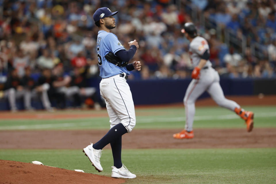 Tampa Bay Rays starting pitcher Taj Bradley walks around the mound as Baltimore Orioles' Gunnar Henderson, behind, circles the bases after hitting a two-run home run during the second inning of a baseball game, Sunday, July 23, 2023, in St. Petersburg, Fla. (AP Photo/Scott Audette)