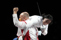 Sun Yiwen of China, left, celebrates with her coach Hugues Obry after winning the women's individual Epee final at the 2020 Summer Olympics, Saturday, July 24, 2021, in Chiba, Japan. (AP Photo/Andrew Medichini)