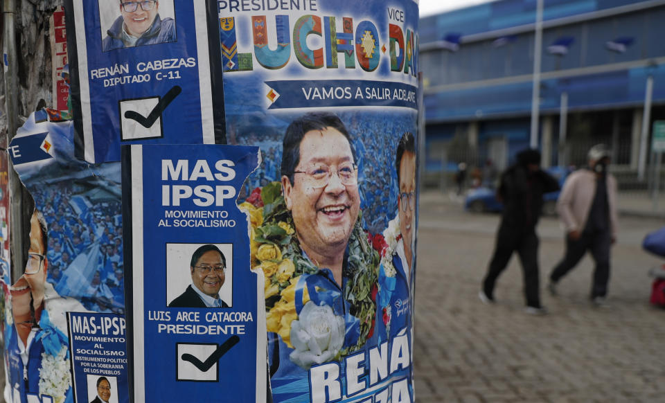 Election posters promoting presidential candidate and one of two leading contenders Luis Arce, representing the Movement Towards Socialism political party better known by its acronym MAS, cover a pole in El Alto, Bolivia, Friday, Oct. 16, 2020. The presidential election on Sunday gives Bolivians a chance for a political reset as they struggle with the dramatic costs of the COVID-19 pandemic. (AP Photo/Juan Karita)