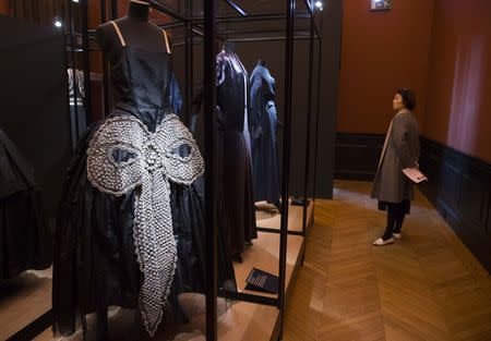 A visitor looks at the dress "La Cavallini" (1925) amongst other creations by late French fashion designer Jeanne Lanvin, during a visit at the Jeanne Lanvin exhibition at the Palais Galliera in Paris, March 6, 2015. REUTERS/Philippe Wojazer