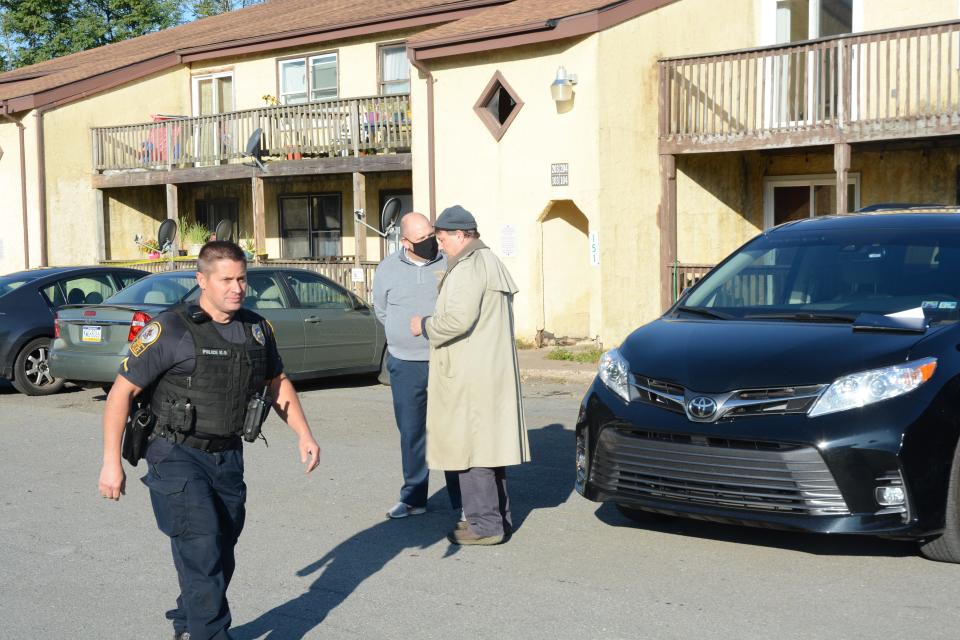 Mike Mancuso, right, the Monroe County first Assistant District Attorney, and Tom Yanac, the Monroe County Coroner, outside the scene of a double homicide on Friday at the Snowshoe Condominiums in Mount Pocono, where a brother and sister were killed and another man, identified as the suspect in their deaths, was wounded.