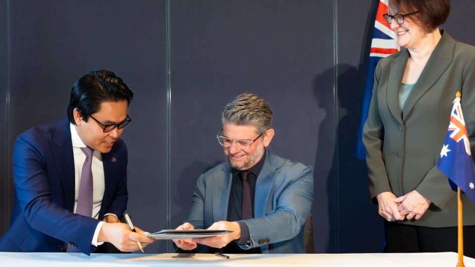 From left to right, Cambodia's ambassador to Australia and New Zealand, Dr. Cheunboran Chanborey; the National Gallery of Australia's director, Nick Mitzevich; and Australian Special Envoy for the Arts Susan Templeman sign a loan agreement in Canberra. - Karlee Holland/National Gallery of Australia