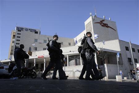 Israeli police officers walk past a post office building in East Jerusalem April 29, 2014. Picture taken April 29, 2014. REUTERS/Ammar Awad