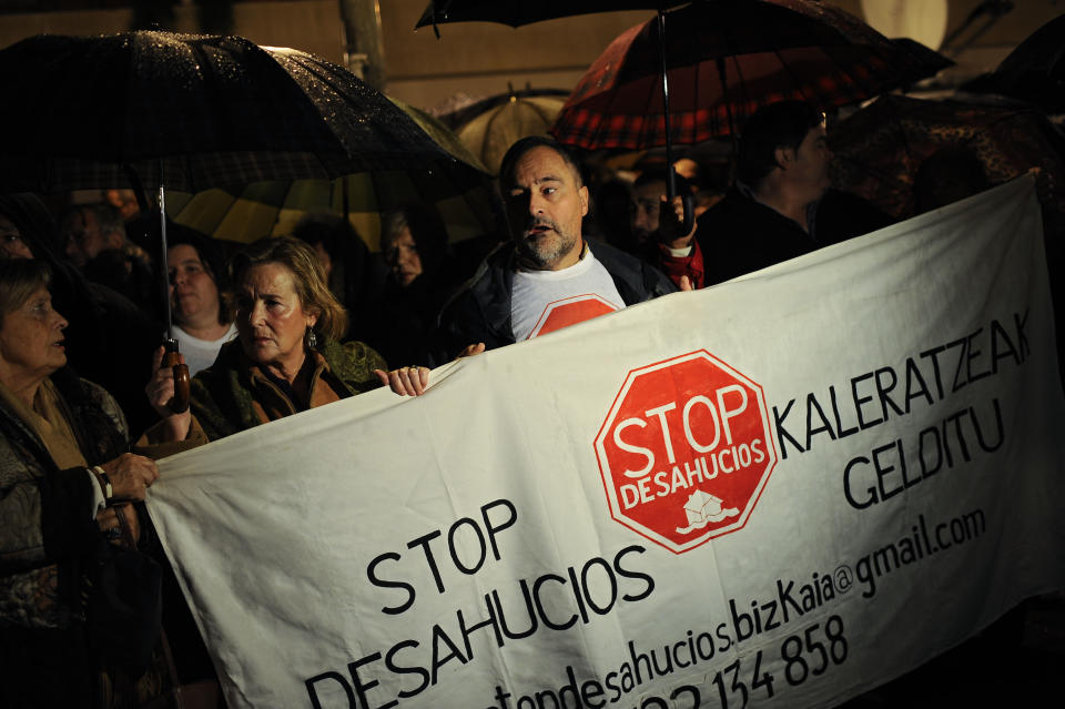 People protest against property evictions, carrying a banner reading, ''Stop Evictions'', during a march in Barakaldo, northern Spain, Friday, Nov. 9, 2012. Officials say a woman fell to her death as bailiffs approached to evict her for non-payment of the mortgage from her fourth-floor apartment in a suburb of the northern Spanish city of Bilbao. Amaia Egana, 53-year-old, who worked at a local bus depot, was married to a former town councilor and had a 21-year-old daughter, launched herself off her balcony Friday, the regional Interior Ministry said.(AP Photo/Alvaro Barrientos)