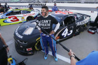 Driver Bubba Wallace is interviewed before a NASCAR Cup Series auto race Wednesday, June 10, 2020, in Martinsville, Va. (AP Photo/Steve Helber)