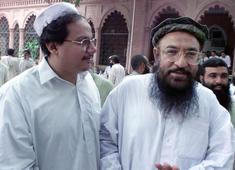 Talha Saeed (L) son of Hafiz Saeed along with Abdur Rehman Makki (R) at the Lahore High Court on July 31, 2002. (AP Photo/str)