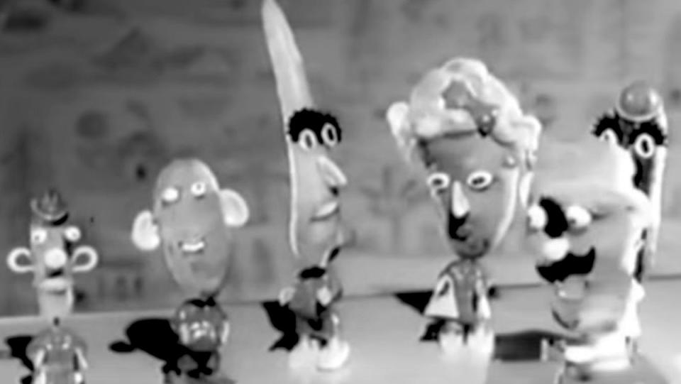 a black and white photo of Mr. and Mrs. Potato heads from vintage ads with real potatoes wearing creepy eyes, hats, and facial hair