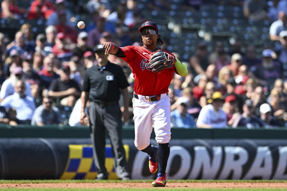 Cleveland Guardians’ José Ramírez throws out Minnesota Twins’ Carlos Santana at first base during the fourth inning of a baseball game, Thursday, Sept. 19, 2024, in Cleveland. (AP Photo/Nick Cammett)