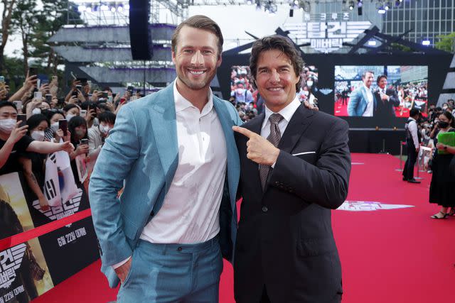 <p>Han Myung-Gu/Getty</p> Glen Powell and Tom Cruise at the Top Gun: Maverick premiere in South Korea