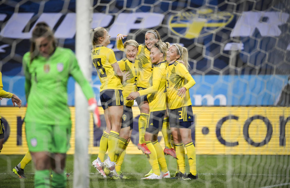 Lina Hurtig, second right, of Sweden celebrate with teammates after scoring the opening goal during the women's international friendly soccer match between Sweden and USA at Friends Arena in Stockholm, Sweden, Saturday, April 10, 2021. (Janerik Henriksson/TT via AP)