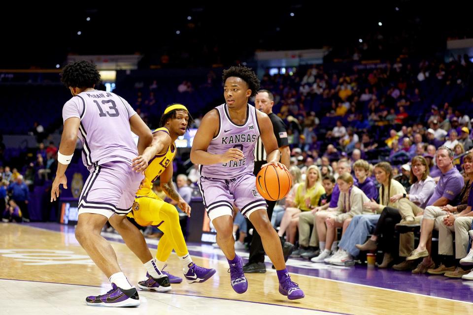 Kansas State's Tylor Perry (2) dribbles around LSU defenders in a nonconference game Saturday, Dec. 9, 2023, at the Pete Maravich Assembly Center in Baton Rouge, Louisiana.