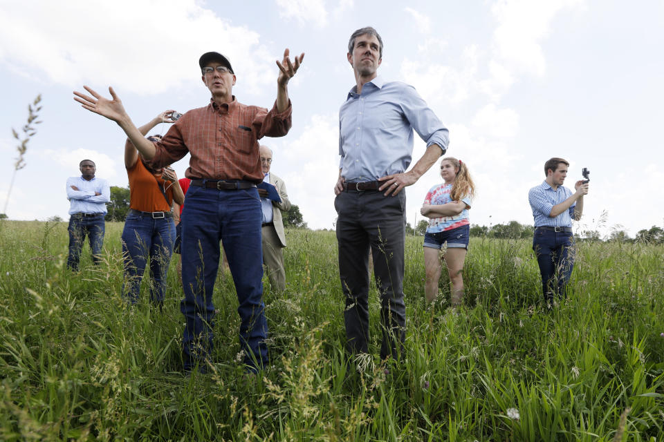 Democratic presidential candidate Beto O'Rourke talks with Matt Russell, left, whiles touring his Coyote Run Farm, Friday, June 7, 2019, in Lacona, Iowa. (AP Photo/Charlie Neibergall)