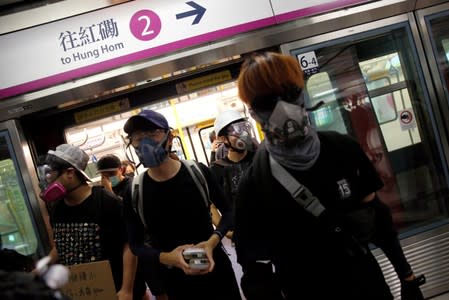 Anti-extradition bill protesters leave a train as they arrive at Siu Hong station during a protest in Hong Kong