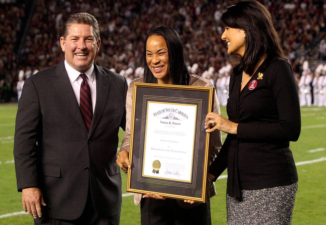 From 2013: Joined by athletic director Ray Tanner, USC’s women’s basketball coach Dawn Staley is awarded the Order of The Palmetto by then Gov. Nikki Haley.