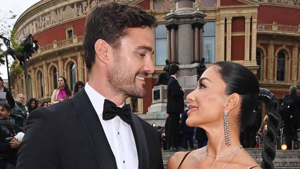 Thom Evans and Nicole Scherzinger look at each other