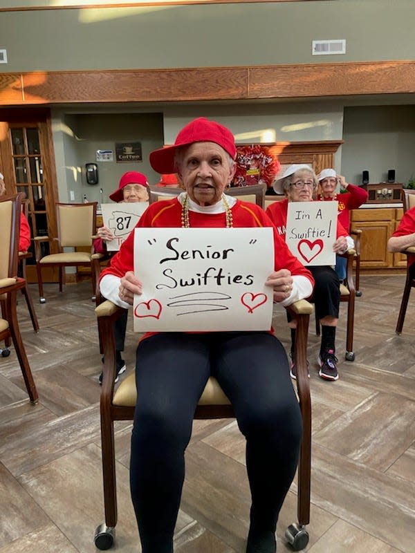 A member of the Primrose Sedalia Chiefs Cheerleaders holds up a sign that says "Senior Swifties" during a routine to "Swag Surfin'" to cheer on the Kansas City Chiefs.