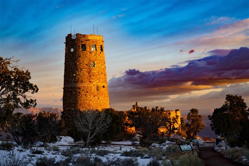 The morning sun illuminates the Desert View Watchtower on the Grand Canyon's South Rim in this February 2019 file photo. The 70-foot-tall building was erected in 1932 and inspired by the "architecture of the Ancestral Puebloan people of the Colorado Plateau," according to Grand Canyon National Park.