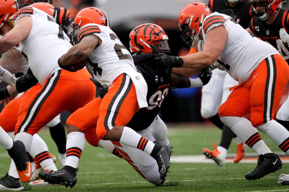 Cincinnati Bengals defensive tackle DJ Reader (98) tackled Cleveland Browns running back Nick Chubb (24) in the second quarter during a Week 14 NFL game, Sunday, Dec. 11, 2022, at Paycor Stadium in Cincinnati. Mandatory Credit: Kareem Elgazzar-The Cincinnati Enquirer-USA TODAY Sports