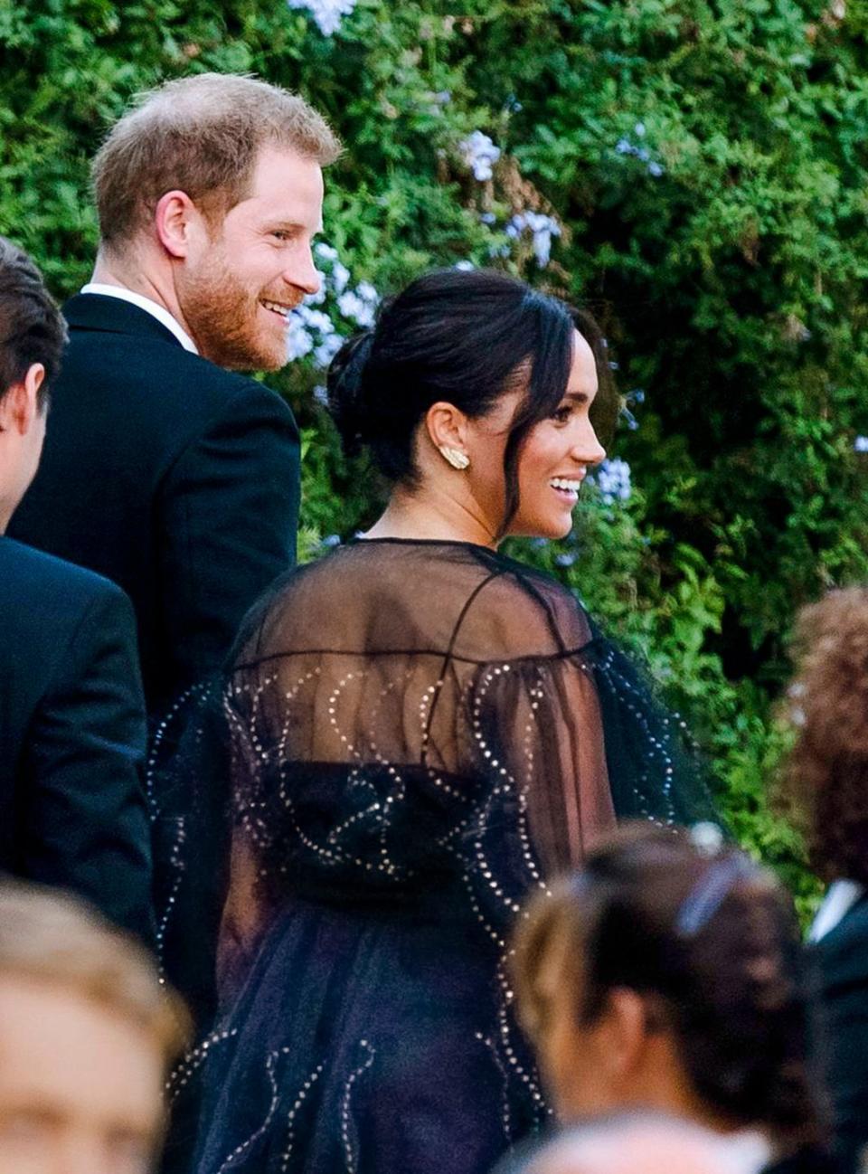 <p>The Duchess of Sussex attended the nuptials of Misha Nonoo (who was rumored to have set her up with her husband Prince Harry) and Mikey Hess in Rome wearing a striking black chiffon dress with metallic embellishment on the whimsical pleats. </p>