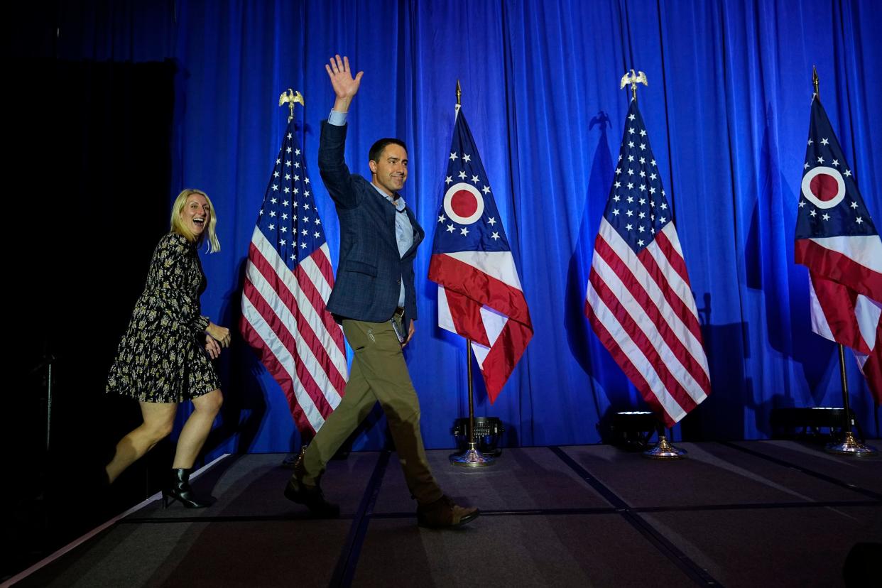 Nov 8, 2022; Columbus, Ohio, USA;  Ohio Secretary of State Frank LaRose waves alongside his wife, Lauren, as he takes the stage during an election night party for Republican candidates for statewide offices at the Renaissance Hotel in downtown Columbus. Mandatory Credit: Adam Cairns-The Columbus Dispatch