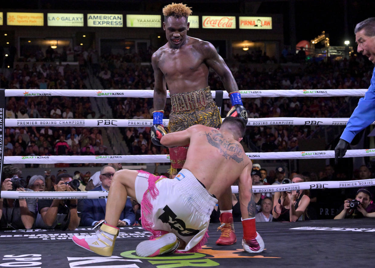 CARSON, CA - MAY 14: Jermell Charlo (gold/red shorts) knocks down Brian Castano (white/pink shorts) during their super middleweight title fight at Dignity Health Sports Park on May 14, 2022 in Carson, California. Charlo won by knockout in the 10th round. (Photo by Jayne Kamin-Oncea/Getty Images)